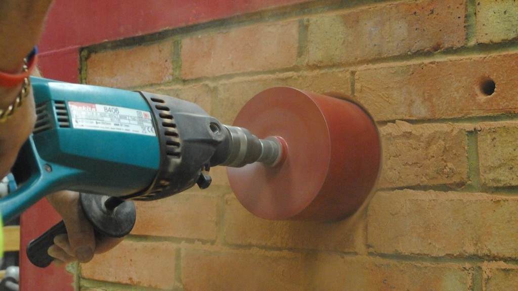 What is a portable electric drill used for?